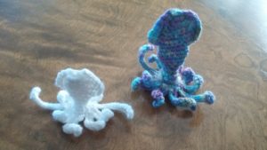 two small crochet octopus creatures